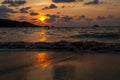 Incredibly picturesque landscape with a view of the waves in the ocean and the bronze sun at the golden hour at sunset in thailand