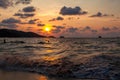 Incredibly picturesque landscape with a view of the waves in the ocean and the bronze sun at the golden hour at sunset in thailand