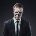 Incredulous businessman with makeup skeleton