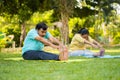 Indain senior couple at morning doing yoga at park - concept of healthy active lifestyle, outdoor fitness and wellness Royalty Free Stock Photo