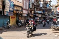 Indan man riding motorcycle in a market