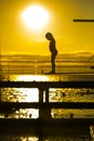 Indecision little girl silhouette on the 3m springboard. Royalty Free Stock Photo