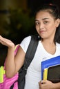 Indecisive Cute Minority Girl Student With Notebooks Royalty Free Stock Photo