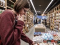 Indecisive woman choosing traditional Catalan sweets