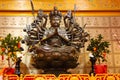 An indefinite sacred religious statue of a Chinese Buddhist temple. Bright colors and orange background