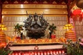 An indefinite sacred religious statue of a Chinese Buddhist temple. Bright colors and orange background