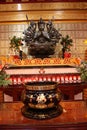 An indefinite sacred religious statue of a Chinese Buddhist temple. Bright colors and orange background