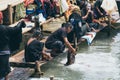 Indein, Myanmar - March 2019: Burmese women from PaO dragon people tribe washing clothes in the river close to Inle lake