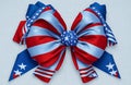 Independence day 4th July emblem with a blue stars bow and curly red and white ribbon to celebrate the declaration of independence