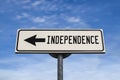 Independence white road sign with arrow, arrow on blue sky background Royalty Free Stock Photo