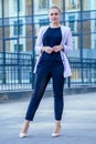 Independent strong and beautiful blonde woman business lady in a fashionable suit and high heels on the street