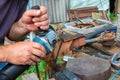 independent tool making using a vise and angle grinder, hands of a wizard, work with hands Royalty Free Stock Photo