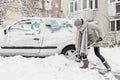 Independent woman shoveling snow in winter.