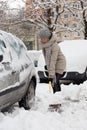 Independent woman shoveling snow in winter.