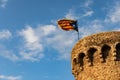 Independentist flag waving on top of medieval tower cloud