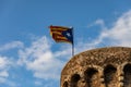 Independentist flag waving on top of medieval tower cloud