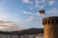 Independentist flag waving on top of medieval tower cloud