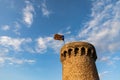 Independentist flag waving on top of medieval tower cloud