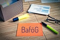 Index cards with legal issues with glasses, pen and bamboo and the german word BafÃÂ¶g to symbolize the german bafÃÂ¶g law for the s Royalty Free Stock Photo