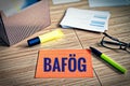 Index cards with legal issues with glasses, pen and bamboo with the german word BafÃ¶g who means the law to support students in ge Royalty Free Stock Photo