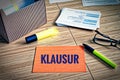 Index cards with legal issues with glasses, pen and bamboo and the german word Klausur in english exam