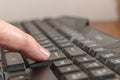 Index finger pressing the enter key on a black computer keyboard Royalty Free Stock Photo