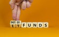 Index funds vs ETF symbol. Businessman turns a cube and changes words `ETF, Exchange-Traded Fund` to `Index funds. Beautiful Royalty Free Stock Photo