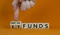 Index funds vs ETF symbol. Businessman turns a cube and changes words `ETF, Exchange-Traded Fund` to `Index funds. Beautiful Royalty Free Stock Photo