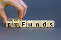 Index funds vs ETF symbol. Businessman turns a cube and changes words `ETF, Exchange-Traded Fund` to `Index funds. Beautiful gr Royalty Free Stock Photo