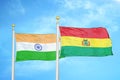 India and Bolivia two flags on flagpoles and blue cloudy sky