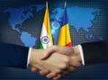 Two person shaking hands in front Chad and Indian flags