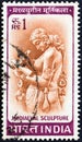 INDIA - CIRCA 1965: A stamp printed in India shows woman writing a letter medieval sculpture, circa 1965.