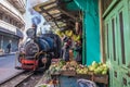 INDIA, DARJEELING. Toy train coming down a narrow street