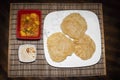 India dish home cooked Poori and mixed vegetable curry along with desert