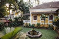 India, Goa - January 8, 2019: Beautiful patio with garden fountain of Portuguese-style yellow house