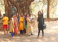 India, GOA, January 18, 2018. A group of Indian girls on a background of a large sacred banyan tree makes a selfie. Selfish on a