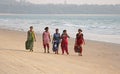 India, GOA, January 22, 2018. A group of Indian women in bright and colorful saris goes along the seashore or the beach. Indian