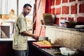 Indian street cook preparing food. Street food. Chef at beach cafes in