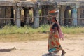 India, Hampi, 02 February 2018. An Indian woman in a sari carries a heavy load on her head. Female labor in India