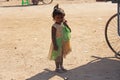 India, Hampi, 02 February 2018. A little poor girl in a dirty dress. Portrait of an indian girl. A girl from India in ornaments