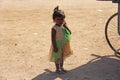 India, Hampi, 02 February 2018. A little poor girl in a dirty dress. Portrait of an indian girl. A girl from India in ornaments