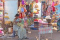 India, Hampi, 02 February 2018. A woman is engaged in needlework, weaves baskets of plastic. The saleswoman in the market. Trade