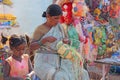 India, Hampi, 02 February 2018. A woman is engaged in needlework, weaves baskets of plastic. The saleswoman in the market. Trade