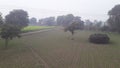 India Haryana former house field in rain season and green grass infield in high voltage Tower Royalty Free Stock Photo