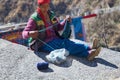 Indian mountaineer woman knits on winter day sitting in sun