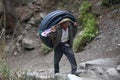 Sherpas mountaineer carries a coil of electric cable