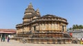 Devotees at.Vidyashankara Temple, rich with sculpted plinth, six doorways and twelve pillars surrounding the mandapa with figures