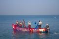 India, Kerala - December 27, 2015: Indian fishermen graphically pull painted Seine right in boat 2. Net painted in bright colors,