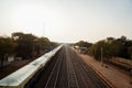 in india a loader train is standing in railway station at left side and a view of empty train metal tracks, a photo from top of Royalty Free Stock Photo