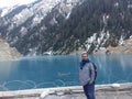 India male at Deep blue frozen water river in winters